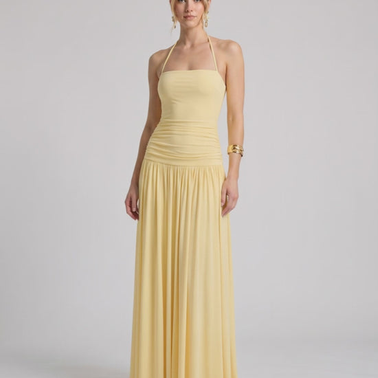 Elara Maxi Dress in soft yellow stretch jersey, features halter neck and ruched waist, by Lauven.