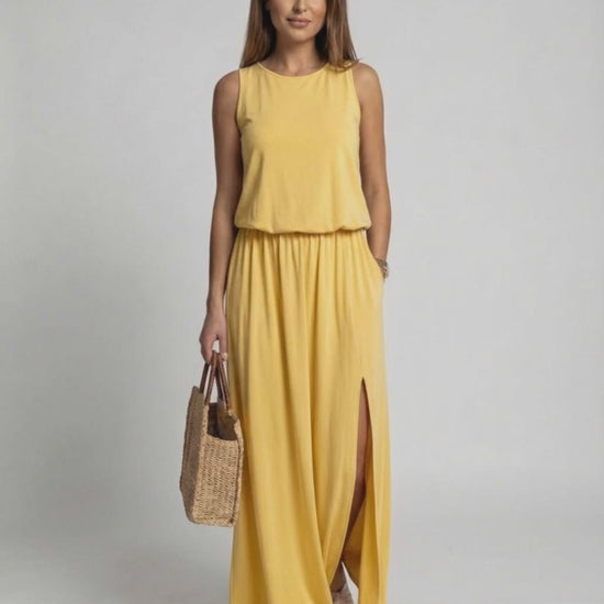Solara Maxi Dress in vibrant yellow, featuring a sleeveless silhouette, side slit, and relaxed fit by Lauven.
