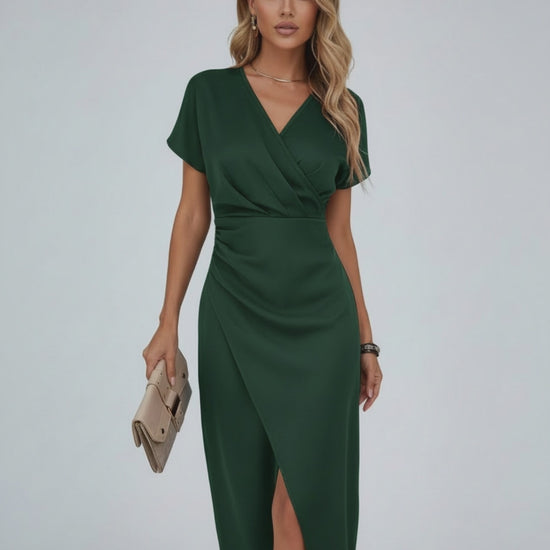 Model wearing Vela Midi Dress by Lauven in dark green with a wrap style and elegant silhouette.