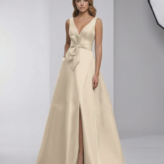 Calista Maxi Dress - elegant satin A-line with bow detail, V-neck, and stylish slit for a refined evening look.