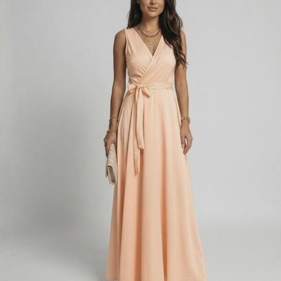 Serena Maxi Dress by Lauven in soft peach, featuring a V-neck silhouette and flowing length for elegant style.