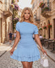 Aurelia Mini Dress in light blue with textured stretch fabric, asymmetrical neckline, and tiered ruffle hem by Lauven.