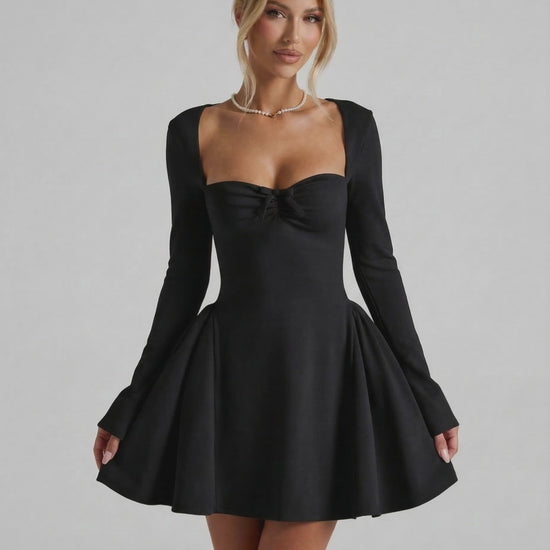 Noir Mini Dress showcasing a flattering fit-and-flare silhouette, long sleeves, and ruched bow detail by Lauven.