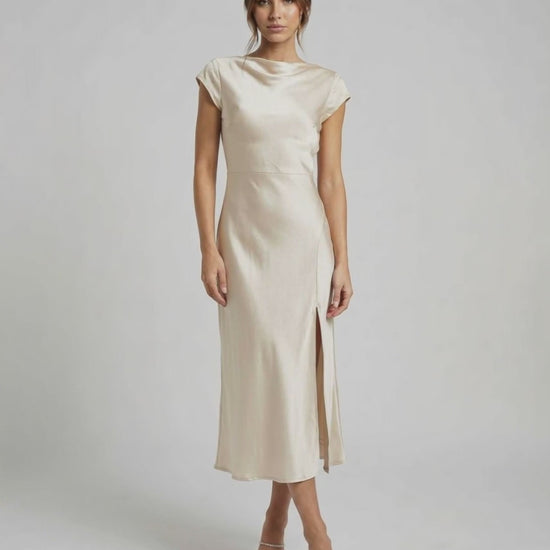 Luna Midi Dress - Classic satin dress with twisted-back, cutout detail, cowl neckline, and soft ivory hue by Lauven.