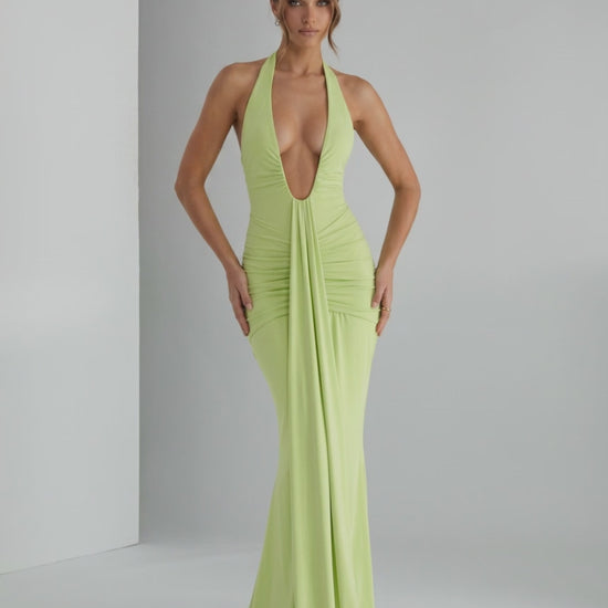 Aurelia Maxi Dress in light green, featuring a halter neck and smooth stretch jersey fabric for a sleek silhouette.