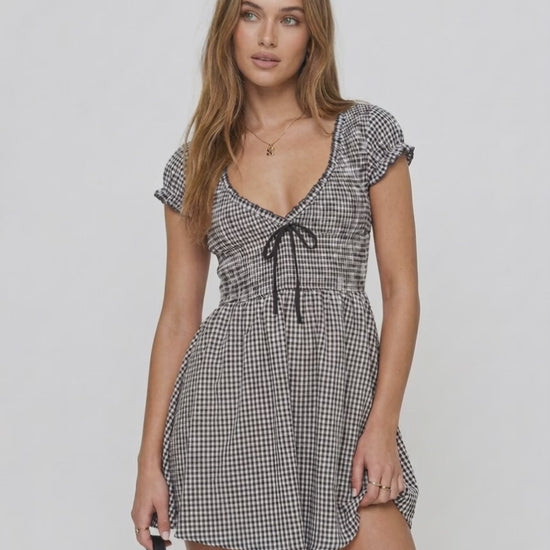Seren Mini Dress by Lauven, featuring gingham check pattern, V-neck, empire waist, and ruffled cap sleeves.