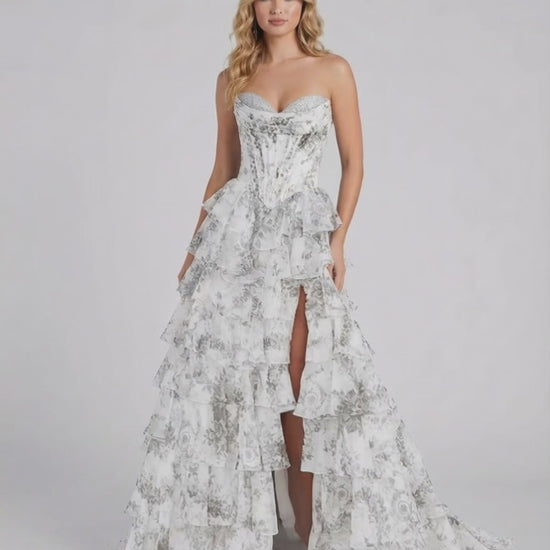 Lunaria Maxi Dress by Lauven, a stunning silver floral tiered chiffon gown with a strapless bodice and high slit.