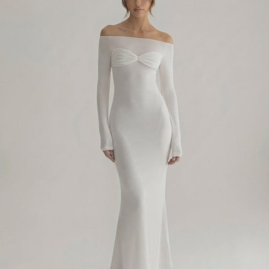 Luna Maxi Dress featuring an elegant off-shoulder neckline, full sleeves, and a smooth white silhouette by Lauven.