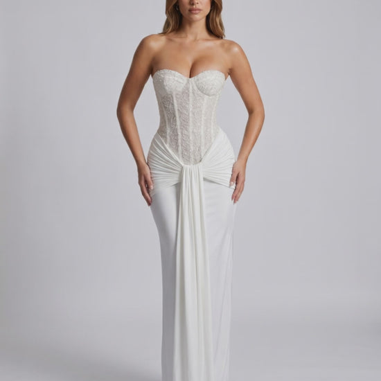 Serelisse Maxi Dress showcasing an off-the-shoulder design, structured corset bodice, and fluid skirt by Lauven.