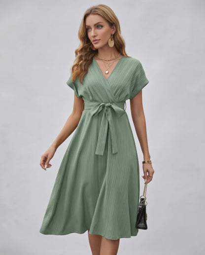 Serene Midi Dress in green, featuring pleated fabric, V-neck, A-line silhouette, and adjustable self-tie belt from Lauven.