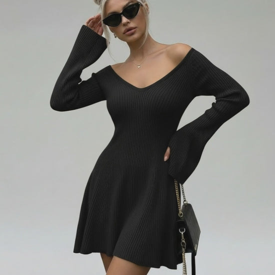 Model wearing Lauven Noir Mini Dress with V-neck and flared sleeves in black knit.