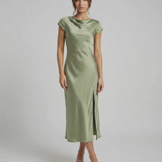 Virgo Midi Dress in soft sage green, featuring sleek satin fabric, twisted-back, and elegant cowl neck by Lauven.