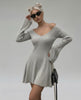 Model wearing Lauven Luna Mini Dress, light gray knit with V-neck and flared sleeves, perfect for stylish occasions.