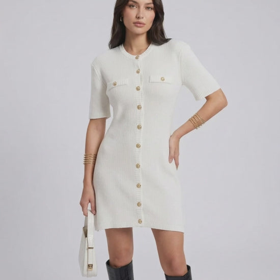 Model wearing the Elysia Mini Dress by Lauven, featuring a casual knit design and single-breasted button closure.