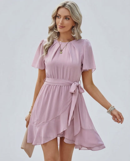 Blush Ruffle Dress by Lauven featuring flutter sleeves and a waist tie, ideal for warm weather elegance.