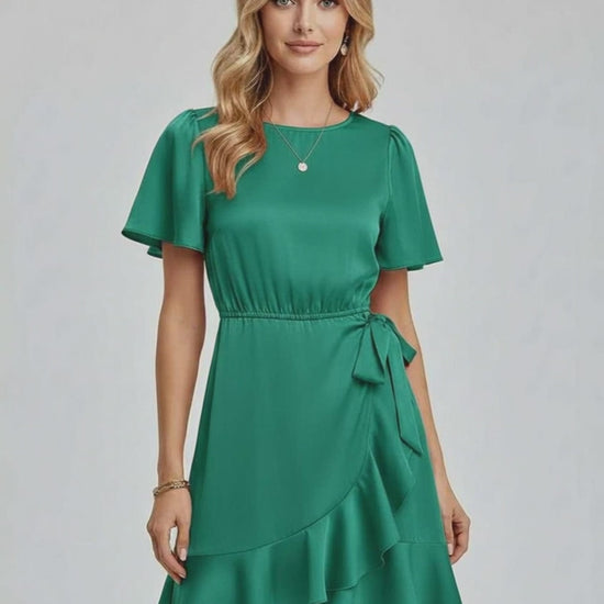 Lauven Selene Mini Dress in emerald green with ruffle detailing and tie waist for a chic summer look.