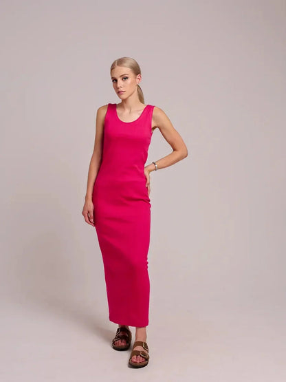Model wearing a sleek fuchsia Radiance Maxi Dress, showcasing its elegant fit and style.