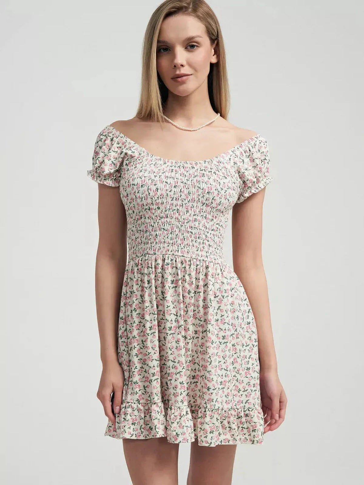 Romantic Blush Blossom summer dress with smocked bodice and pink floral print on milk-white fabric.