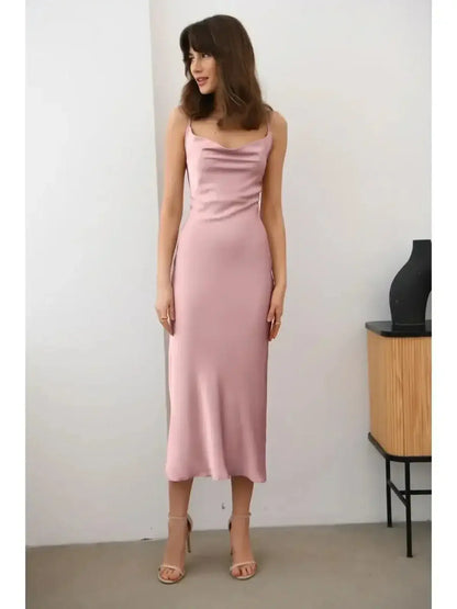 Model showcasing the Roselle Midi Dress in muted rose satin, featuring a sleek silhouette and elegant drape.