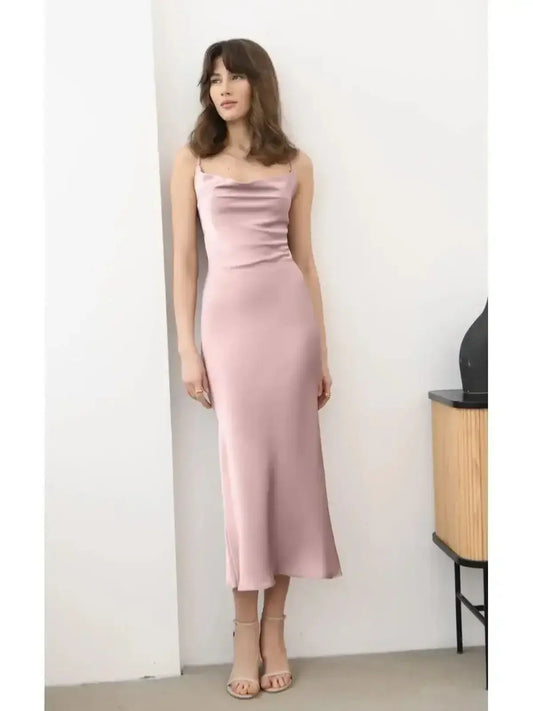 Model wearing a Roselle Midi Dress in muted rose satin, showcasing a sleek silhouette and elegant drape.