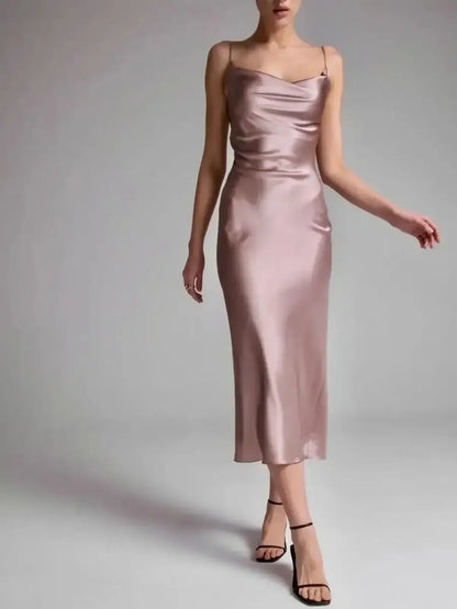 Sleek Roselle Midi Dress in muted rose satin, featuring elegant draping and a flattering silhouette for evening occasions.