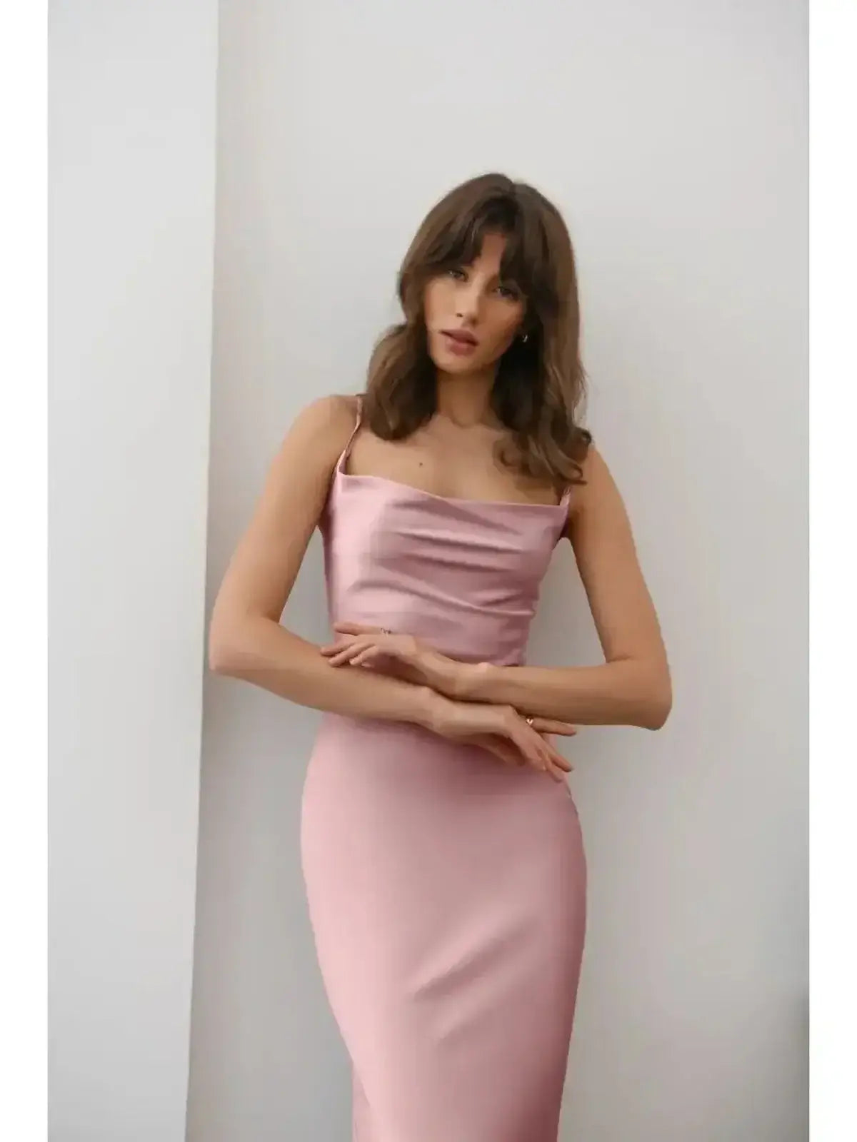 Model wearing Roselle Midi Dress featuring luxe satin drape in muted rose tone, showcasing elegant silhouette and minimal refinement.