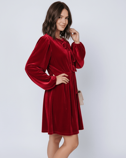 Ruby Mini Dress by Lauven, featuring rich red velvet, long lantern sleeves, and a flowing skirt for an elegant silhouette.