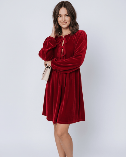 Ruby Mini Dress by Lauven featuring elegant red velvet fabric with lantern sleeves and a flowing skirt.