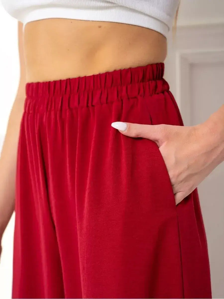 Ruby Suit Set by Lauven showcasing vibrant red wide-leg trousers with side pocket detail.