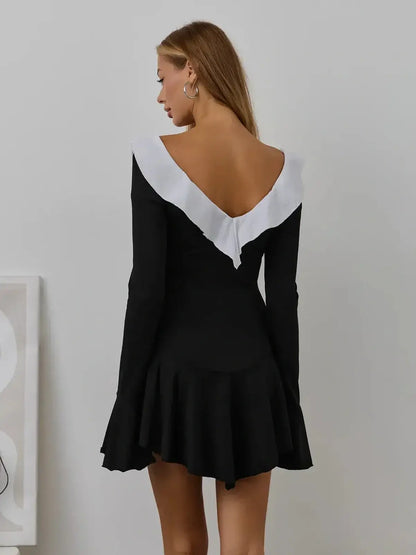 Black mini dress with white ruffle neckline and long sleeves, perfect for weddings and formal occasions.