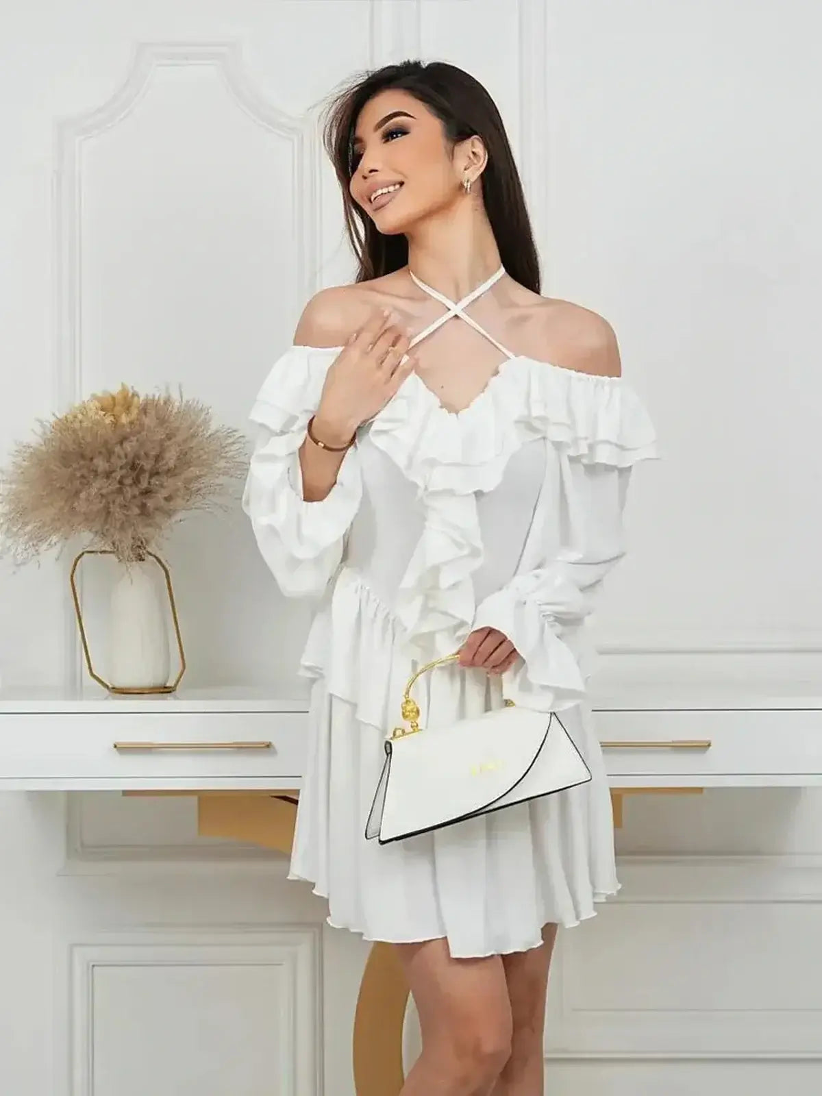 Elegant woman wearing a Ruffle Bloom Mini Dress, featuring off-shoulder design and flared skirt, perfect for summer occasions.