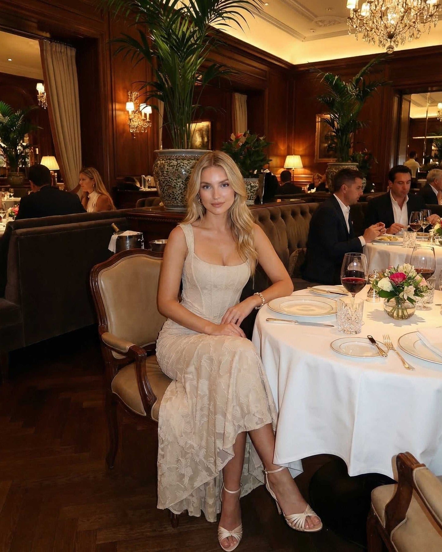 Sable Maxi Dress worn in an elegant restaurant setting by Lauven, showcasing a sophisticated square neckline and fish tail hem.