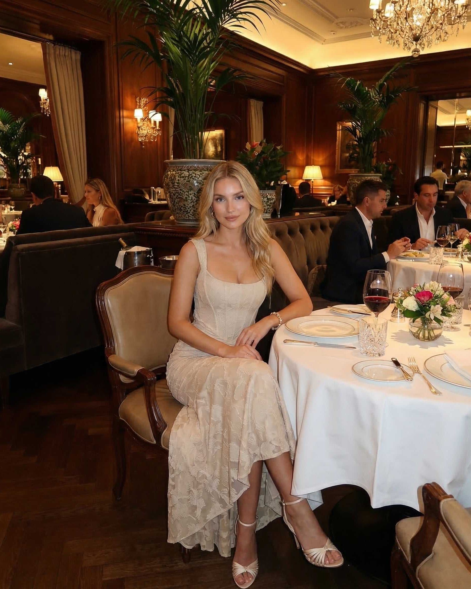 Sable Maxi Dress worn in an elegant restaurant setting by Lauven, showcasing a sophisticated square neckline and fish tail hem.