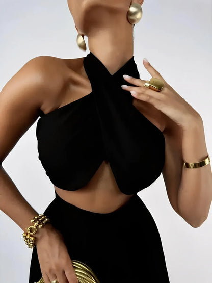 Model wearing a black Sable Twist Set, highlighting the asymmetric halter crop top and stylish accessories.