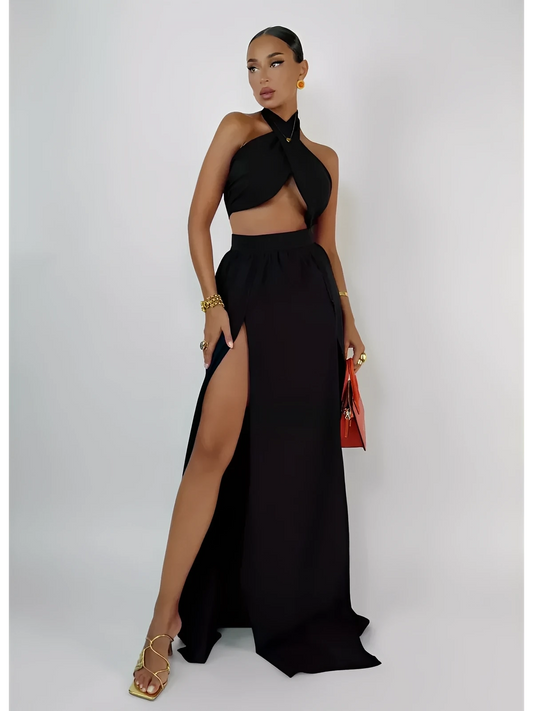 Model showcasing the Sable Twist Set: a black asymmetric crop top and high-waisted slit skirt, exuding elegance and confidence.