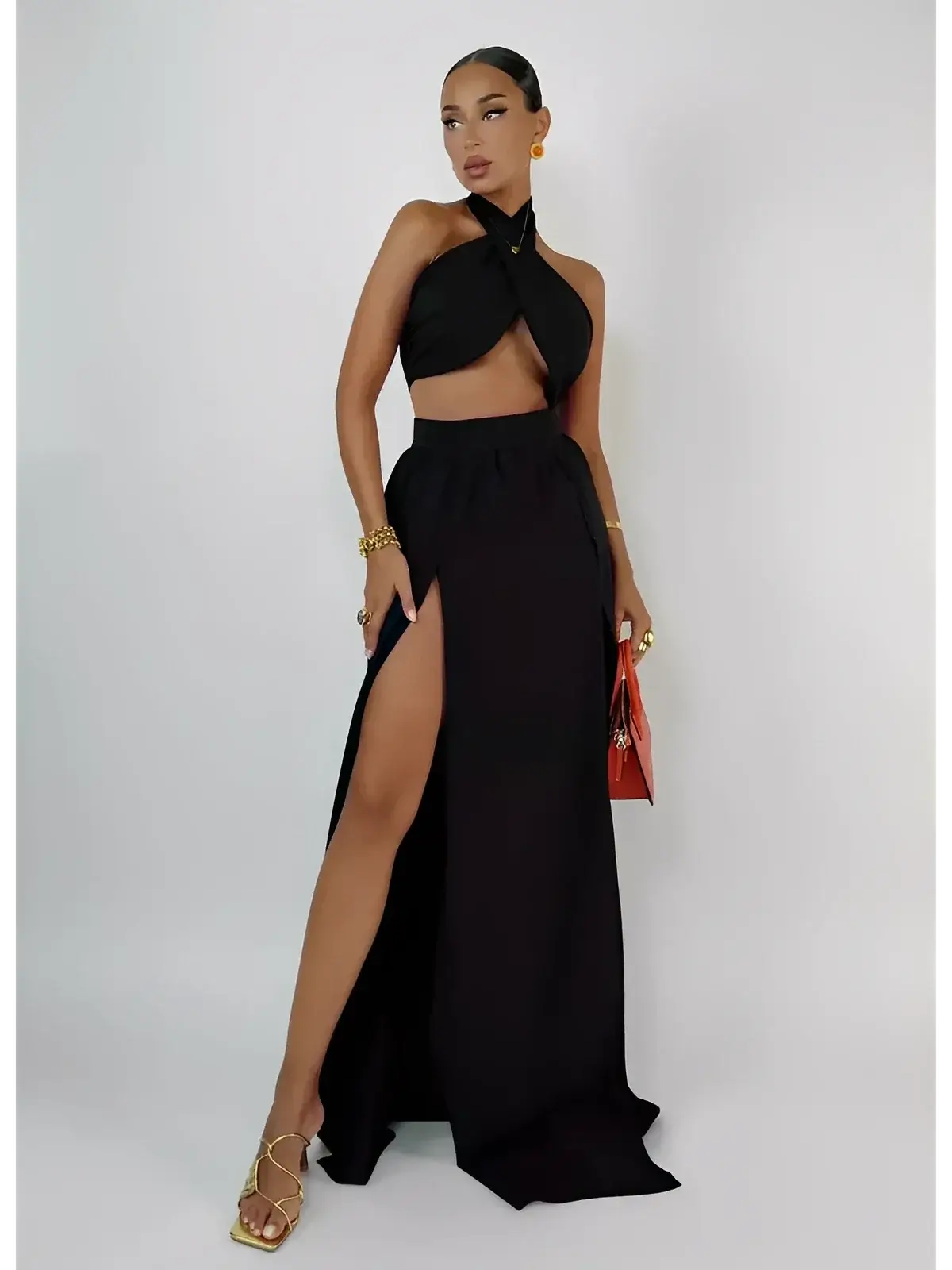 Sable Twist Set by Lauven featuring a black asymmetric crop top and high-waisted maxi skirt with slit.