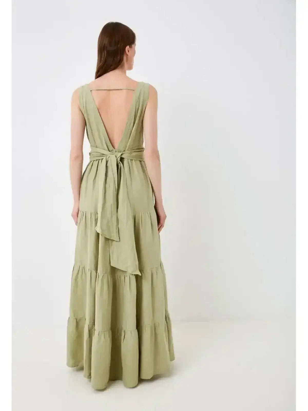 Back view of Sage Whisper Maxi Dress in olive green, showcasing its elegant wrap-style belt and gathered tiers.