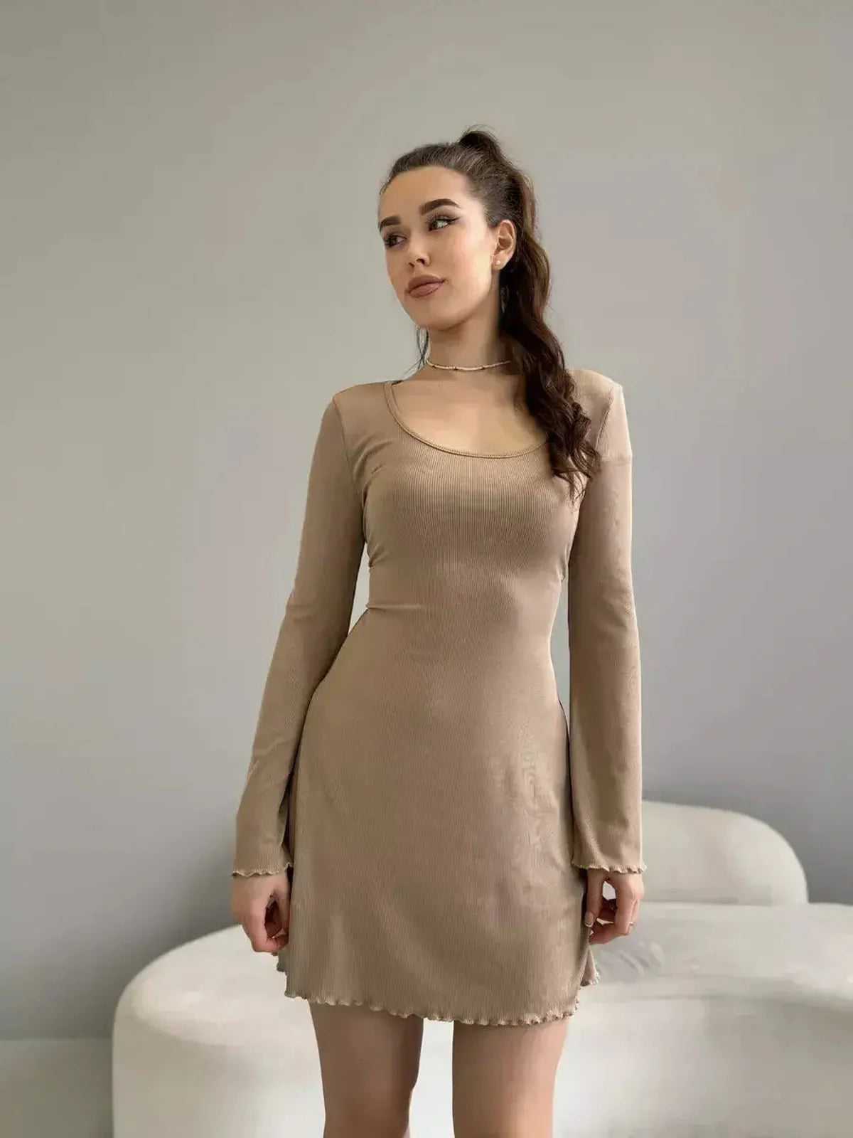 Sahara Glow neutral-tone mini dress featuring a ribbed knit fabric, long sleeves, and a flared cuff for women's summer cocktail attire.