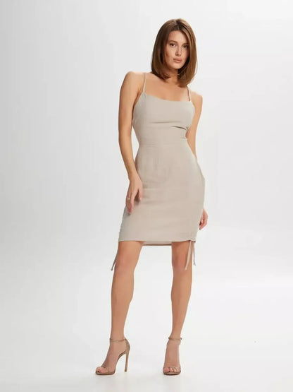 Lauven Sand Dune mini dress featuring adjustable straps and lace-up back for summer elegance.