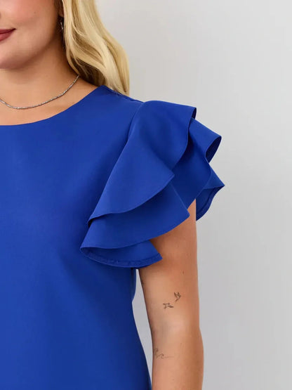 Close-up of sapphire blue mini dress with cascading ruffle sleeves, showcasing effortless elegance for summer fashion.