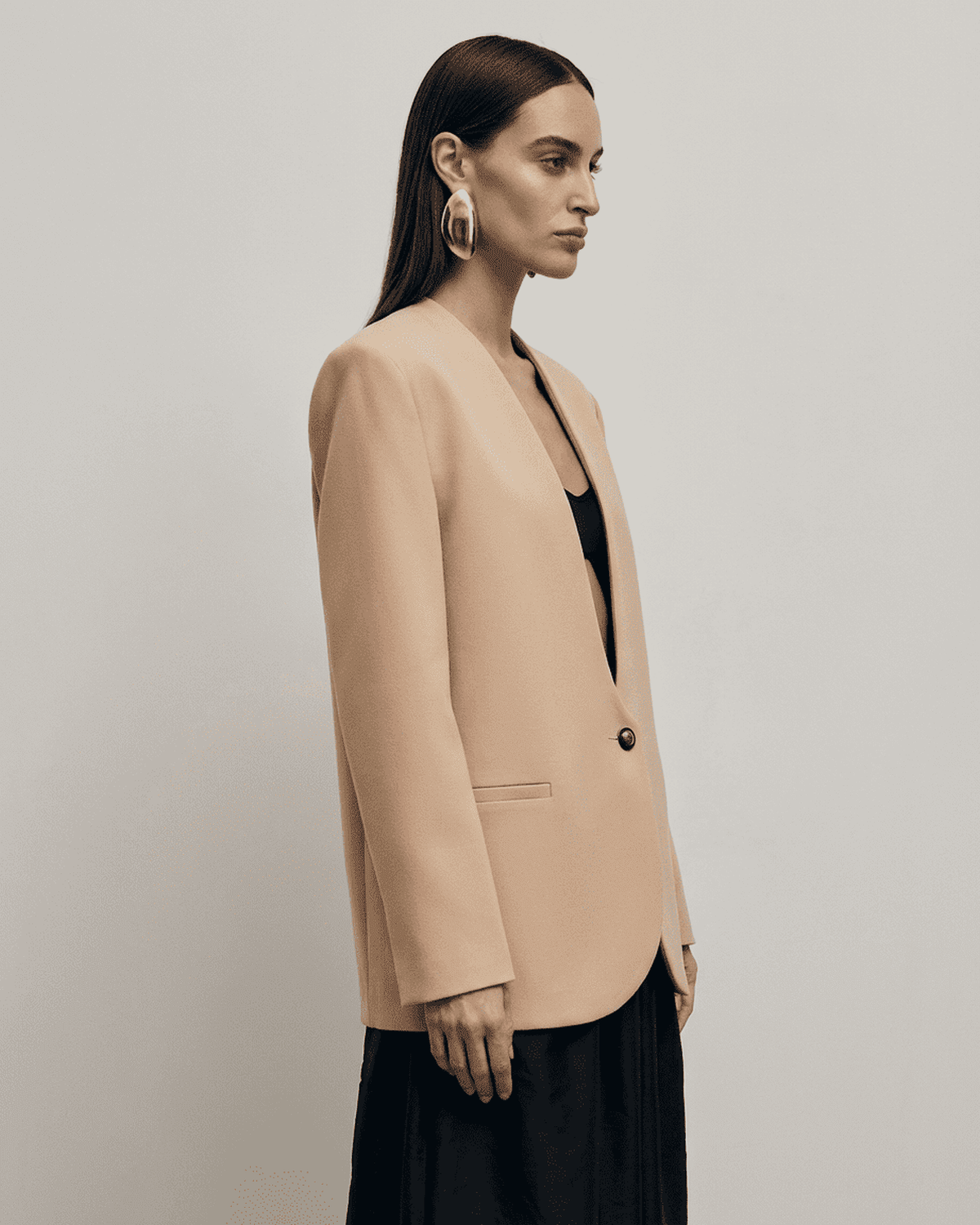 Savona Blazer by Lauven, a fitted beige women's blazer with a V-neckline and structured shoulders.