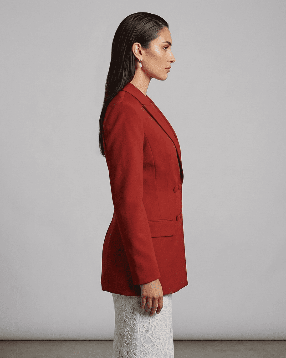 Profile view of a model wearing a Scarlet Blazer from Lauven, featuring sharp lapels and tailored silhouette.