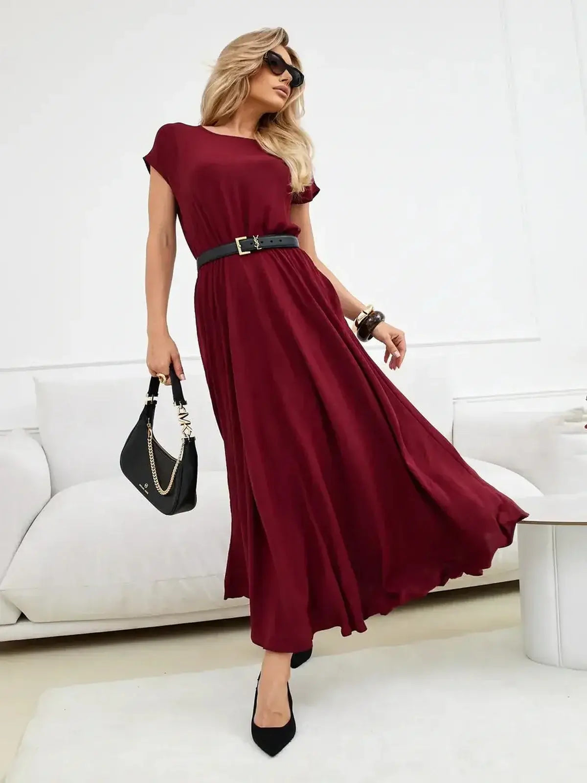 Woman modeling a burgundy Sculpted Ease Maxi Dress with a cinched waist and flowing skirt for laid-back elegance.