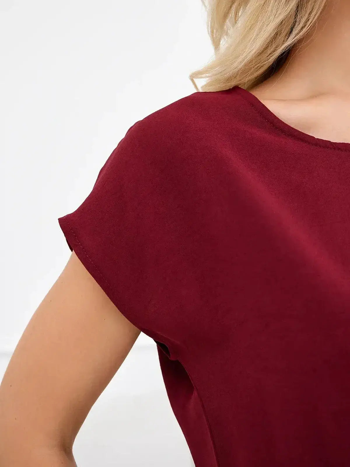Close-up of the Sculpted Ease Maxi Dress in deep burgundy, showcasing soft fabric and elegant neckline details.