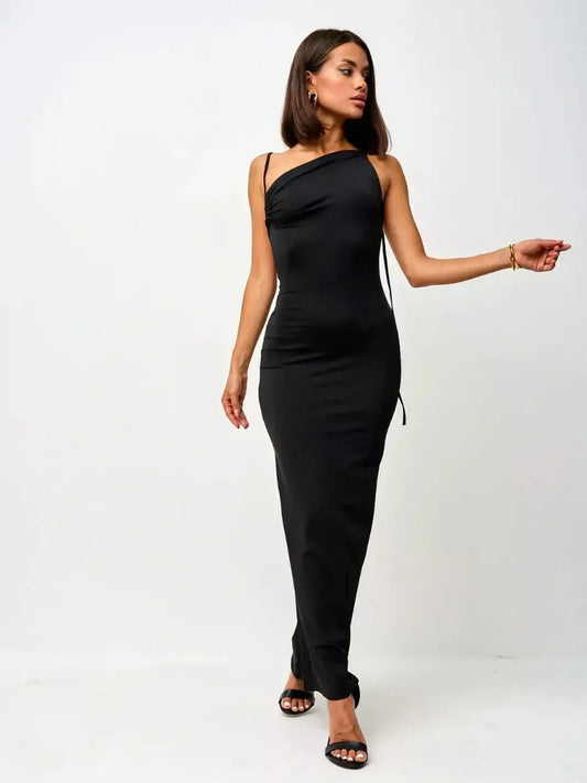 Model showcasing the Sculpted Elegance Maxi Dress, a sleek black gown with convertible straps and a ruched bodice.