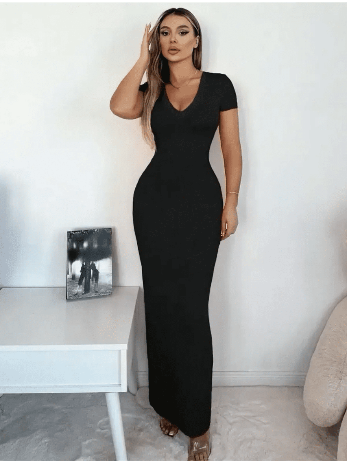 Model showcasing Sculpted Elegance Maxi Dress in black, featuring a flattering V-neck and form-fitting silhouette.