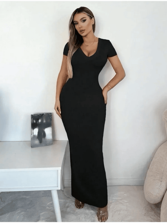 Model wearing a Sculpted Elegance Maxi Dress featuring a flattering V-neckline and sleek fit, showcasing minimalist glamour.