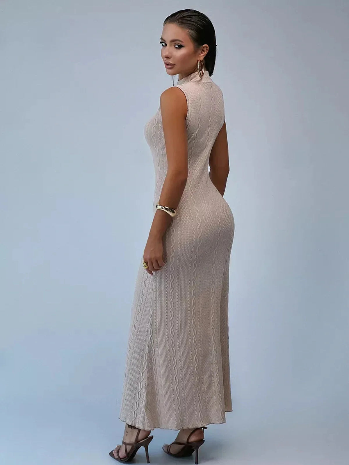 Model showcasing the Sculpted Grace Maxi Dress in a soft beige, highlighting its sleek silhouette and sculpted neckline.