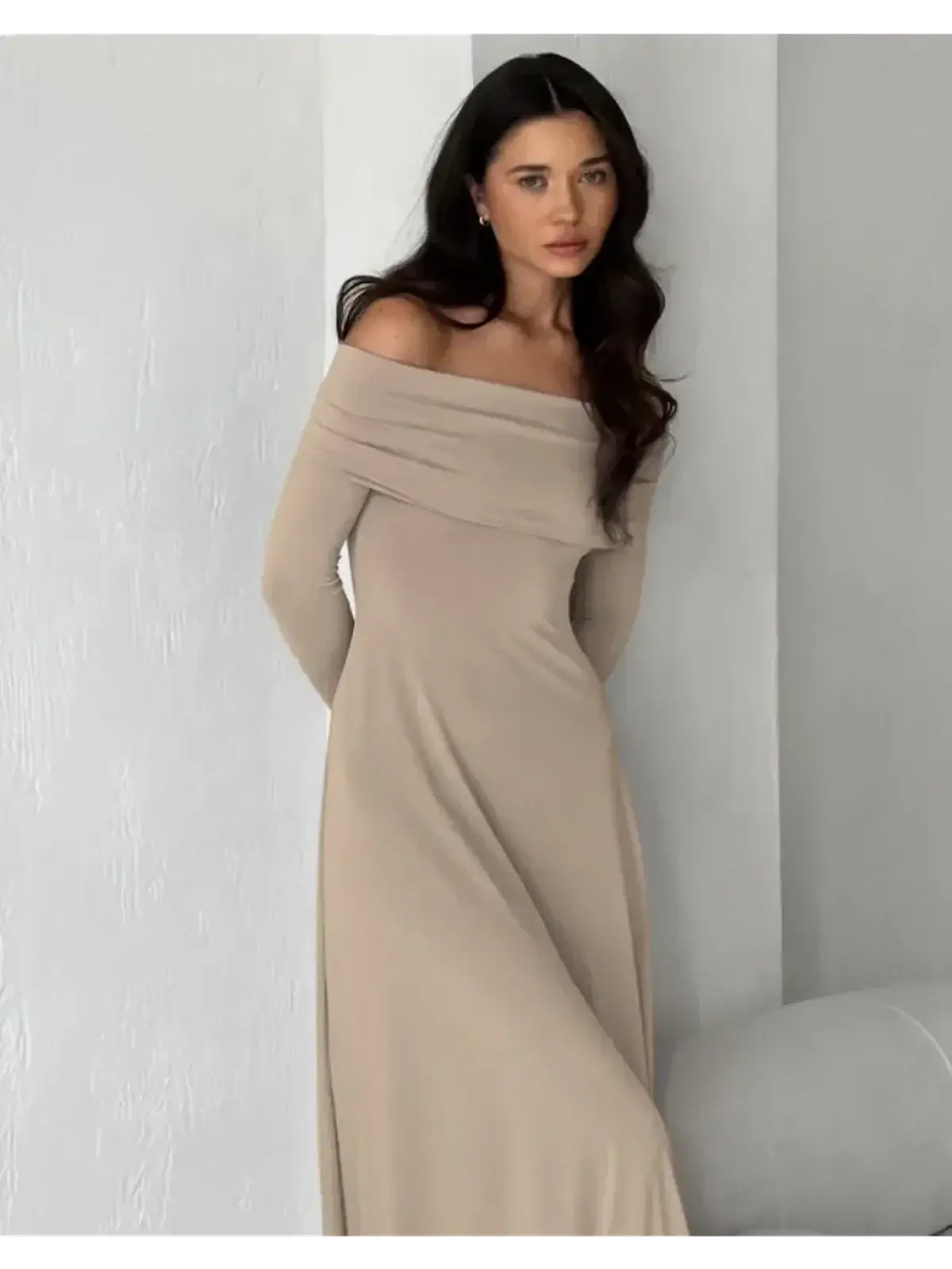 Off-shoulder cappuccino-toned maxi dress showcasing elegant silhouette and body-hugging fabric for refined comfort.