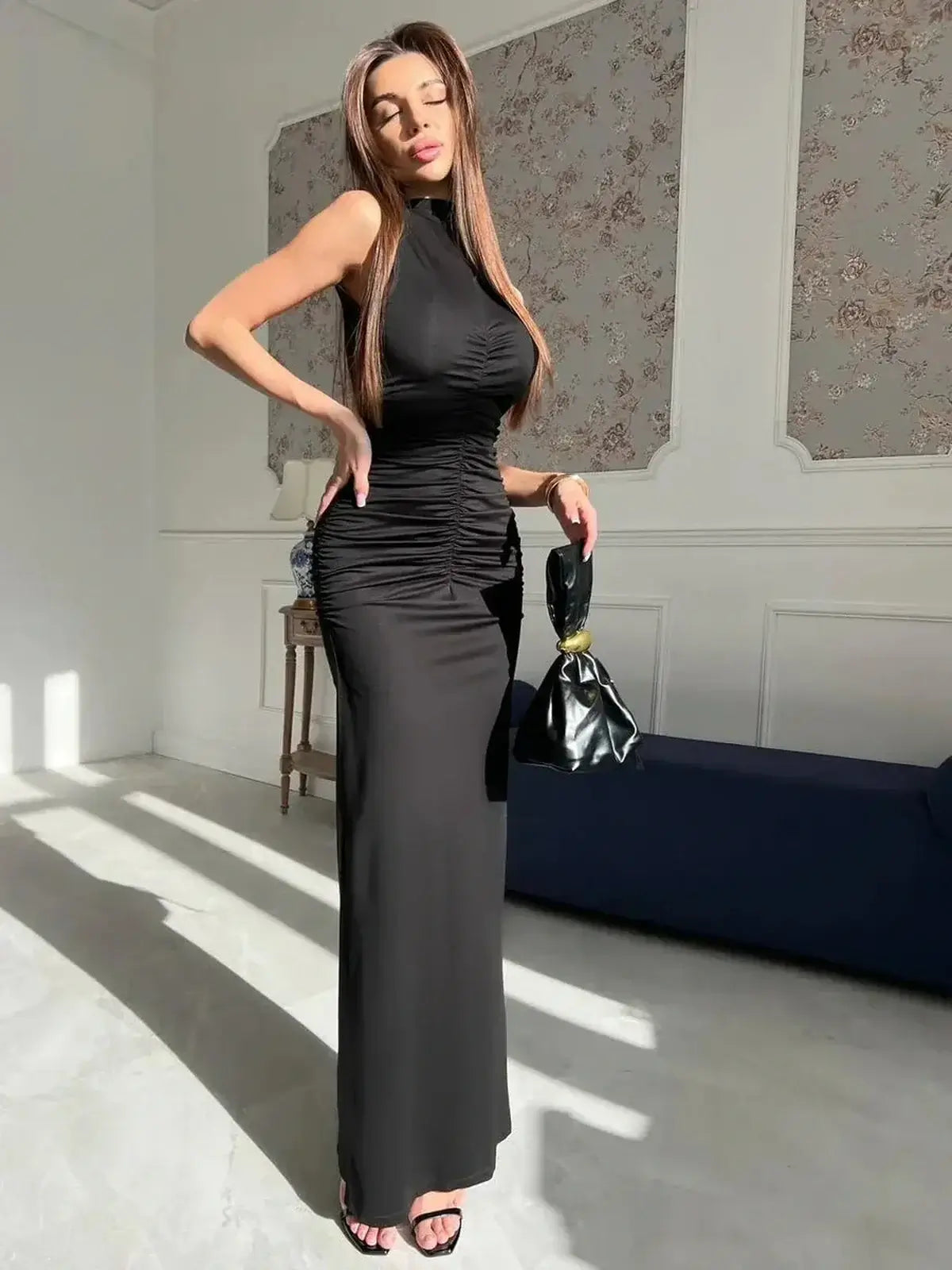 Sculpted Grace Maxi Dress showcasing elegant draping and a sleek silhouette in deep black with satin sheen.